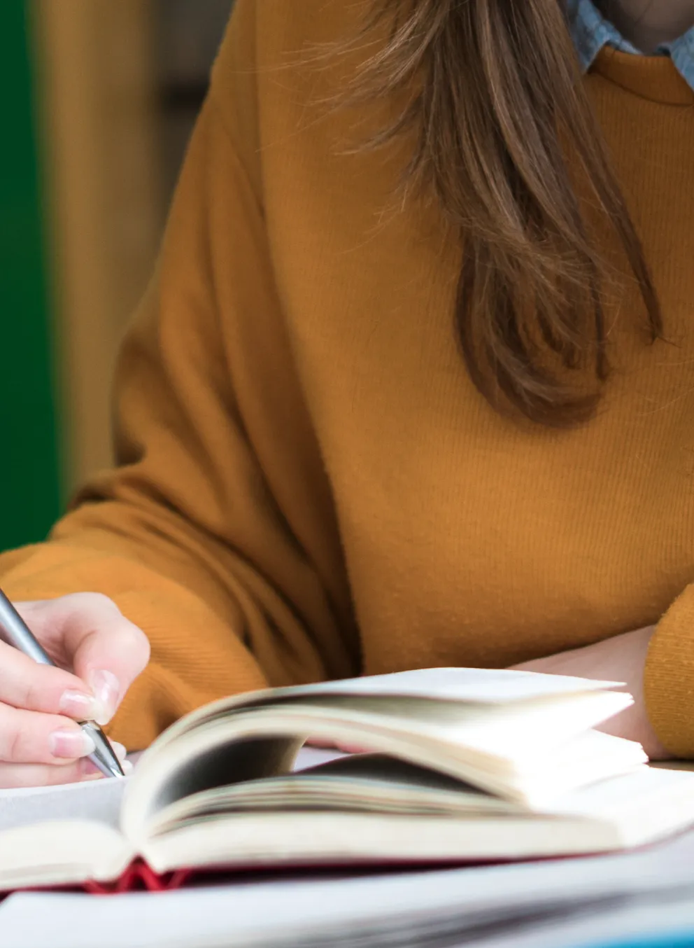 People are reading a notebook together