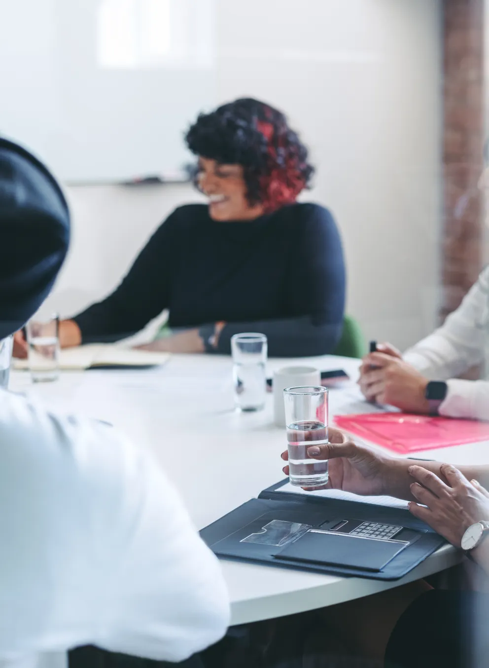 Group of people sitting together around a table speaking