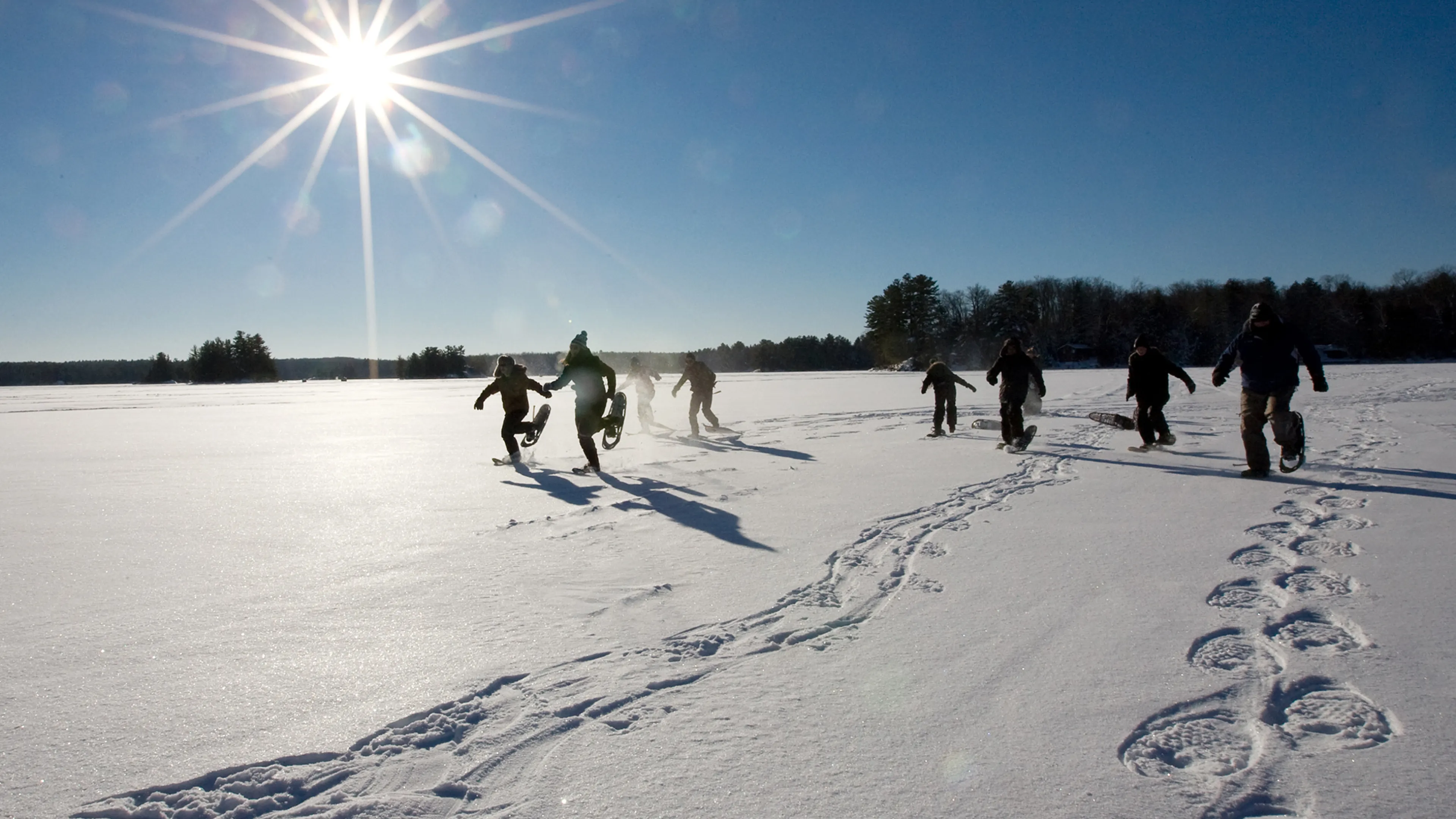 Youth snowshoeing on frozen lake